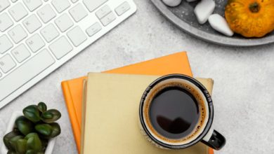 Productivity planner, coffee, and laptop on a work desk