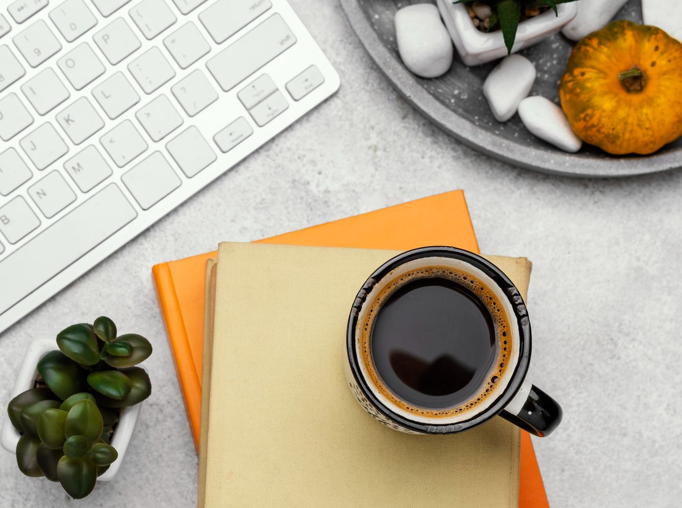 Productivity planner, coffee, and laptop on a work desk